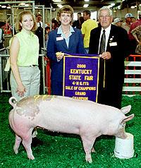 Donna Hancock accepts the banner for her grand champion market hog.
