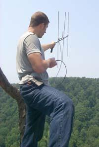 Matt Dzialak uses a battery- operated transmitter and antenna to locate the falcons in the area.
