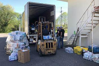 Loading a semi with fencing materials and cleaning supplies at the Graves County Cooperative Extension office. The materials will be headed to Nebraska to help farmers impacted by record flooding in March 2019. Photo by Samantha Anderson