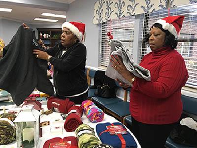 (l-r) Beverly Persley and Gloria Coleman help Pine Meadows residents pick out gifts for themselves and loved ones.