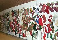 Stocking chair Jennifer LaPointe holds two of the many stockings donated to benefit Kosair Children's Hospital. This wall of stockings, below, was only part of the stockings made for the annual event. 