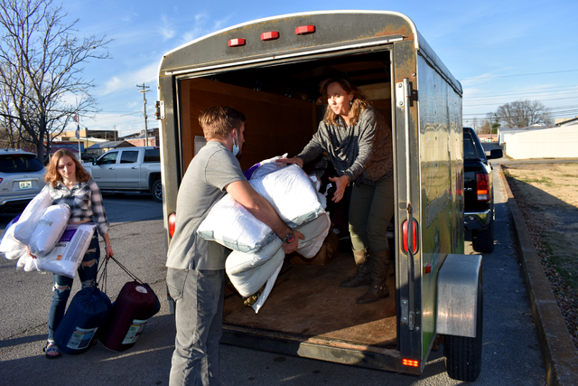 Todd County 4-H'er Andrew McDonald hands bedding supplies to Lee Ann McCuiston, Todd County 4-H youth development agent, who was loading a trailer of supplies to take the West Kentucky 4-H Camp in Dawson Springs.