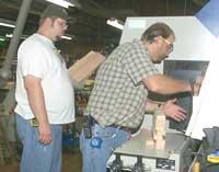 Ammerman demonstrates how to enter wood products into a computerized moulder.