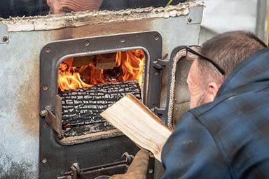James Sword of Sweet Life Farms in Pikeville, Kentucky adding wood to the wood fire under the evaporator tank. James Sword of Sweet Life Farms in Pikeville, Kentucky adding wood to the wood fire under the evaporator tank.