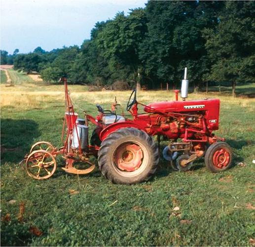 Harry Young hooked a modified mule-drawn two-row planter to a small tractor to plant the first crop of commercial no-till corn in 1962. Photo courtesy of No-Till Farmer.