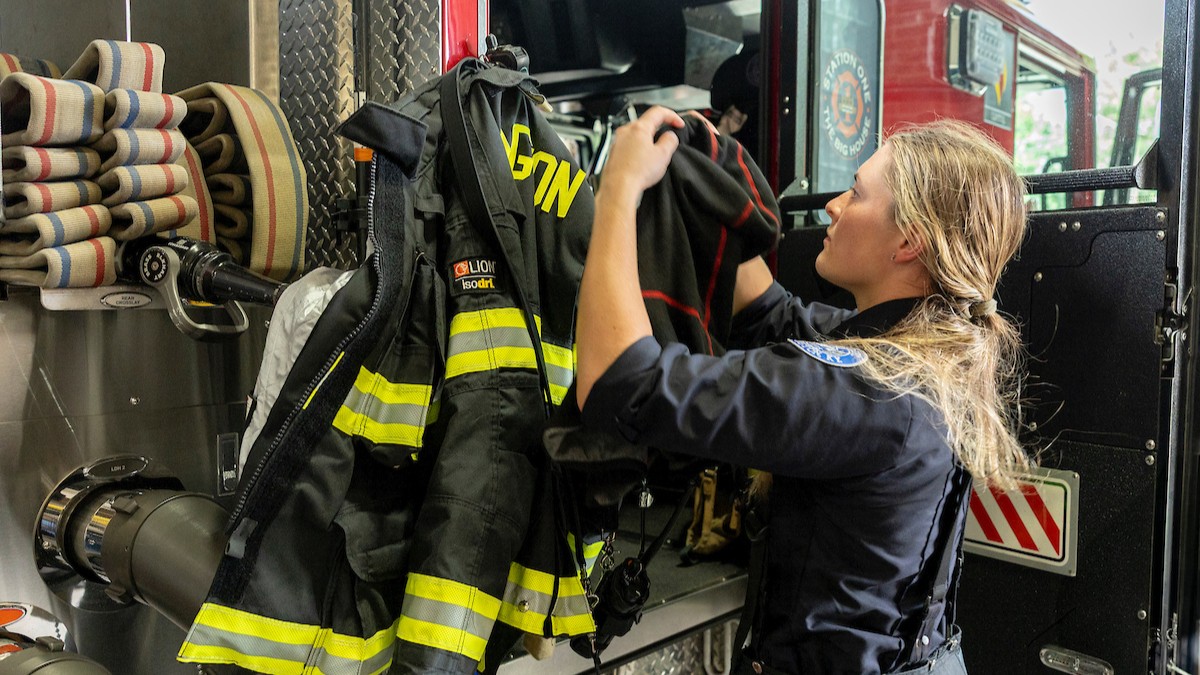 Lexington firefighter putting on the turnout gear. Photo by Sabrina Hounshell.