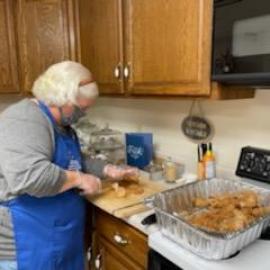 Cecelia Hostilo, Trigg County family and consumer sciences extension agent, prepares food for members of the Kentucky National Guard stationed in Lyon County. Photo by Jill Harris, Todd County FCS agent.