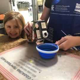 A little girl enjoys cooking with her mom with help online from Perry County NEP assistant Reda Fugate.