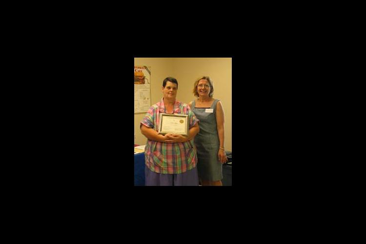 Ann Wynn, left, receives a certificate honoring her weight loss achievement. Also pictured is Christine Rivera, Caldwell County family and consumer science agent.
