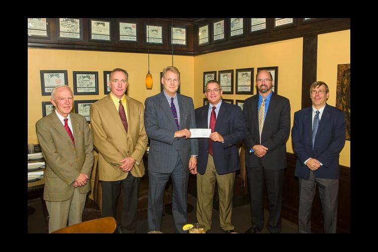 Gluck Equine Research Center Director Dr. Mats Troedsson received a check from Patrick Talley, Lloyd's Regional Director. 
