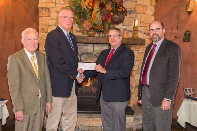 Pat Talley (Center Right), Regional Director, U.S. Central Lloyd's America,  gives Dr. David Horohov (Center Left), Chair, Department of Veterinary Science,  a check on behalf of Underwriters at Lloyd's, London to support publication of the Equine Disease