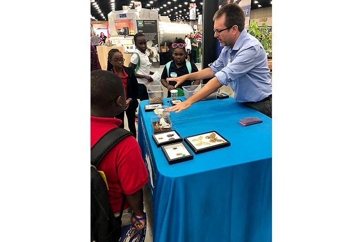 Blake Newton, UK entomology 4-H/youth extension specialist, shows fairgoers some of UK entomology's insect zoo during the 2018 Kentucky State Fair. 