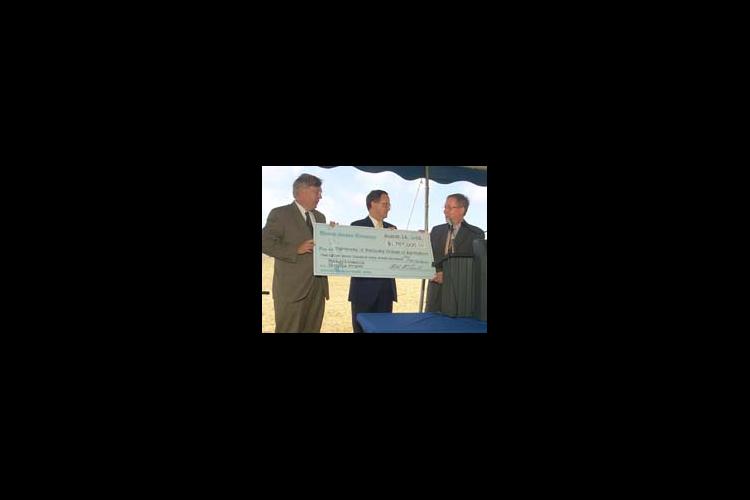 Dr. Scott Smith (left) and Dr. Lee Todd (middle) accept the research funding check from U.S. Senator Mitch McConnell.