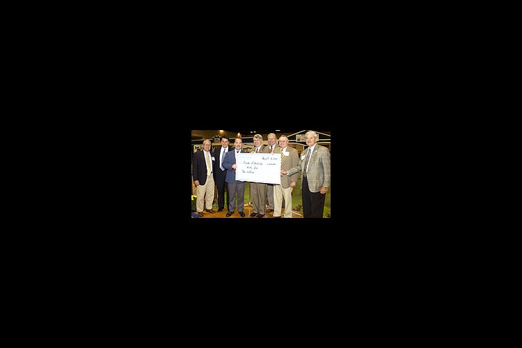 UK dean of agriculture Scott Smith (center) holds the 4-H $2 million check with Kentucky agriculture commissioner Billy Ray Smith (far right) and members of the Kentucky Agricultural Development Board during the 4-H Friends breakfast at the State Fair.