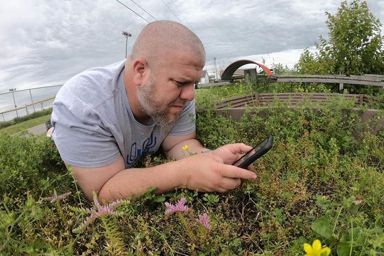 Eric Comley, Garrard County 4-H youth development agent, records a native plant for his YouTube series, "On the Ground." Photo by Eric Comley. 