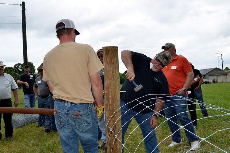 Logan County cattle producer Butch King participates in an on-site fence construction during a 2019 Kentucky Fencing School. Photo by Katie Pratt, UK agricultural communications.