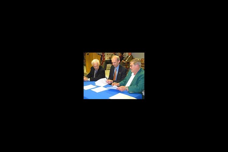 Robert Shay, Larry Turner and Larry Dotson sign a memorandum of understanding to work together in promoting fine arts in Kentucky.