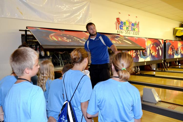 Cody Shannon explains the mechanics behind a his bowling alley to children attending the Community Passport Adventure Camp.  Photo by Katie Pratt, UK agricultural communications.