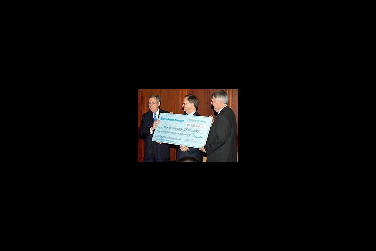 Senator McConnell presents a check to UK President Lee T. Todd, Jr. and UK College of Agriculture Dean Scott Smith. 