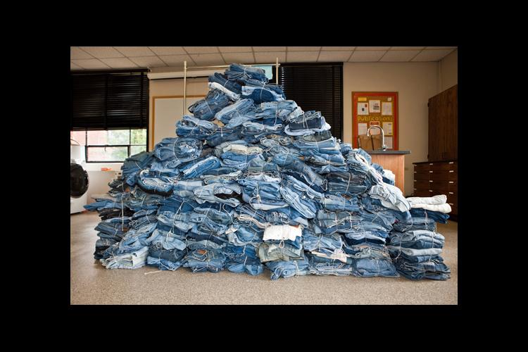 A pile of jeans collected during a previous year's denim drive.