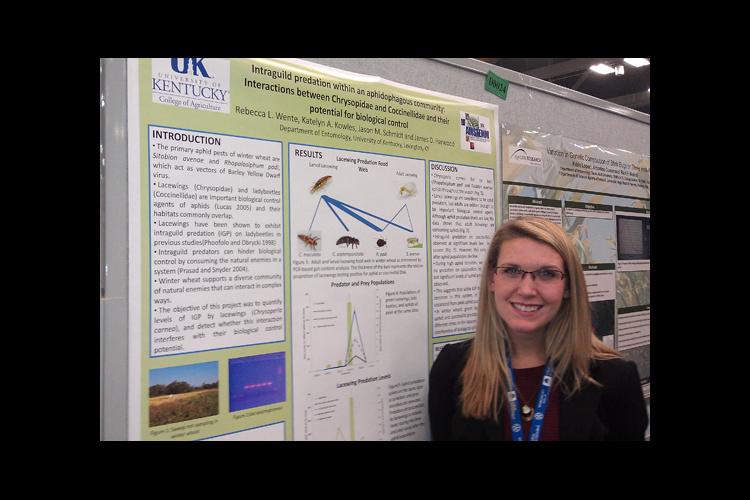 Rebecca Wente stands beside her award-winning poster at the Entomological Society of America annual meeting. 