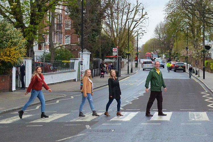 UK students from left: Catie Archambeau, Arizzona Albright and Emma Rosenzweig and Jason Swanson, UK associate professor, recreate the famous Beatles album cover at the Zebra Crossing at Abbey Road Studios in London. Photo by Wilson Blakeman. 