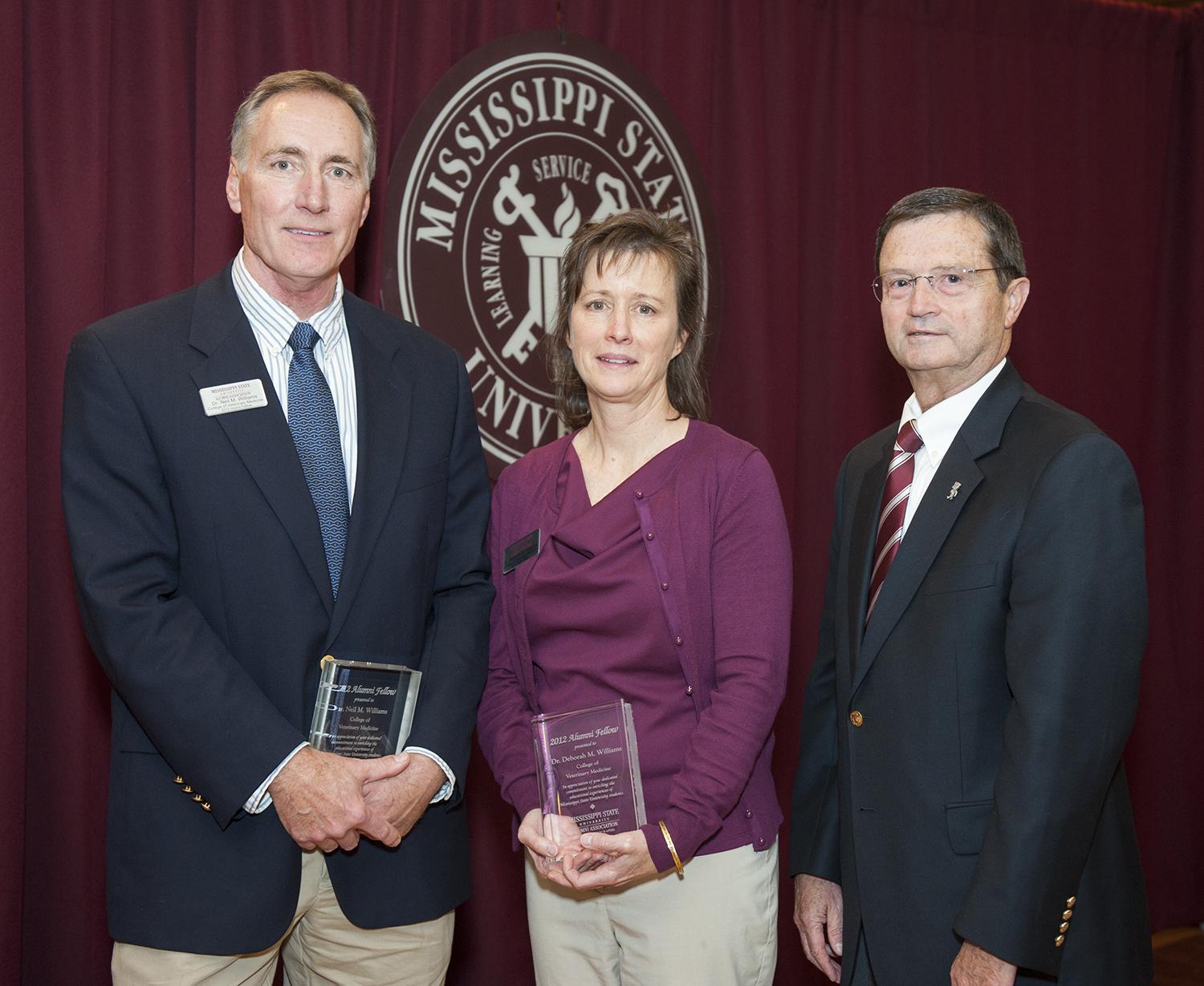 Dr. Neil M. Williams, left, and his wife Dr. Deborah Maples Williams, with Kent Hoblet, dean of the MSU College of Veterinary Me 