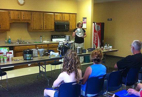 Laura Peek, Washington County EFNEP assistant, demonstrates food preservation techniques during the Back to Basics program. 