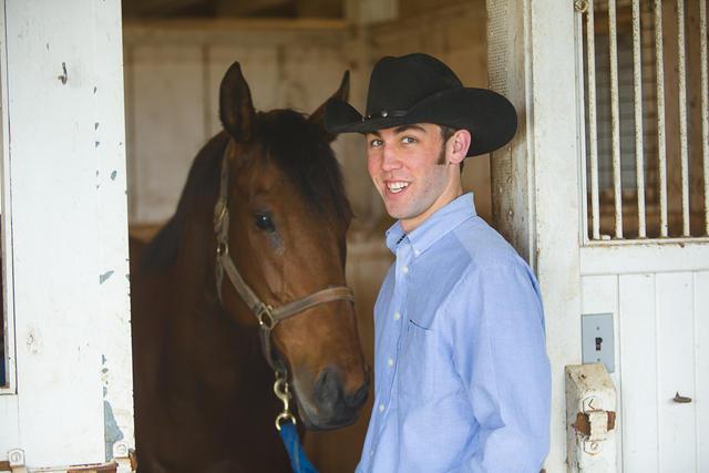 UK student Colton Woods works with horses at UK's Maine Chance Farm. 