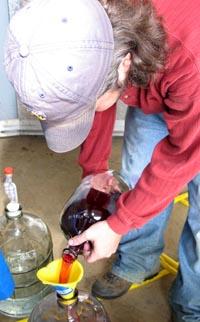 Brandon O'Daniel prepares wine for the bottling process.  
