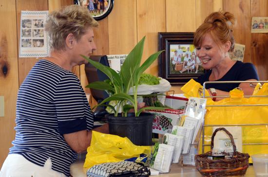 CSA member Donna McMurtrie,left, picks up her weekly share from Cathy Stempien at Brumfield's roadside market. 