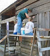 people cleaning cabin exterior