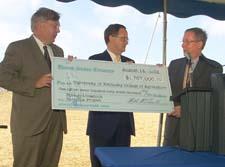 Dr. Scott Smith (left) and Dr. Lee Todd (middle) accept the research funding check from U.S. Senator Mitch McConnell.