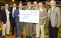 UK dean of agriculture Scott Smith (center) holds the 4-H $2 million check with Kentucky agriculture commissioner Billy Ray Smith (far right) and members of the Kentucky Agricultural Development Board during the 4-H Friends breakfast at the State Fair.