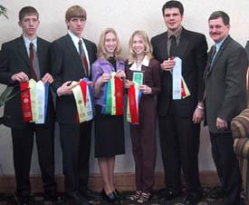 The 2002 Meat Judging team display their ribbons with coach Benjy Mikel (far right).