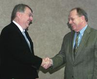 Scott Smith (left), dean of the College of Agriculture, shakes hands with Emery Wilson, dean of the College of Medicine following the signing.