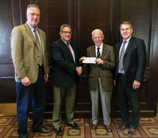 (l-r) David Horohov, Pat Talley, Peter Timoney, Rick Bennett. Talley presents Timoney with check from Lloyd's of London. 