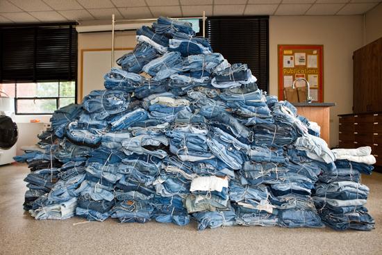 A pile of jeans collected during a previous year's denim drive.