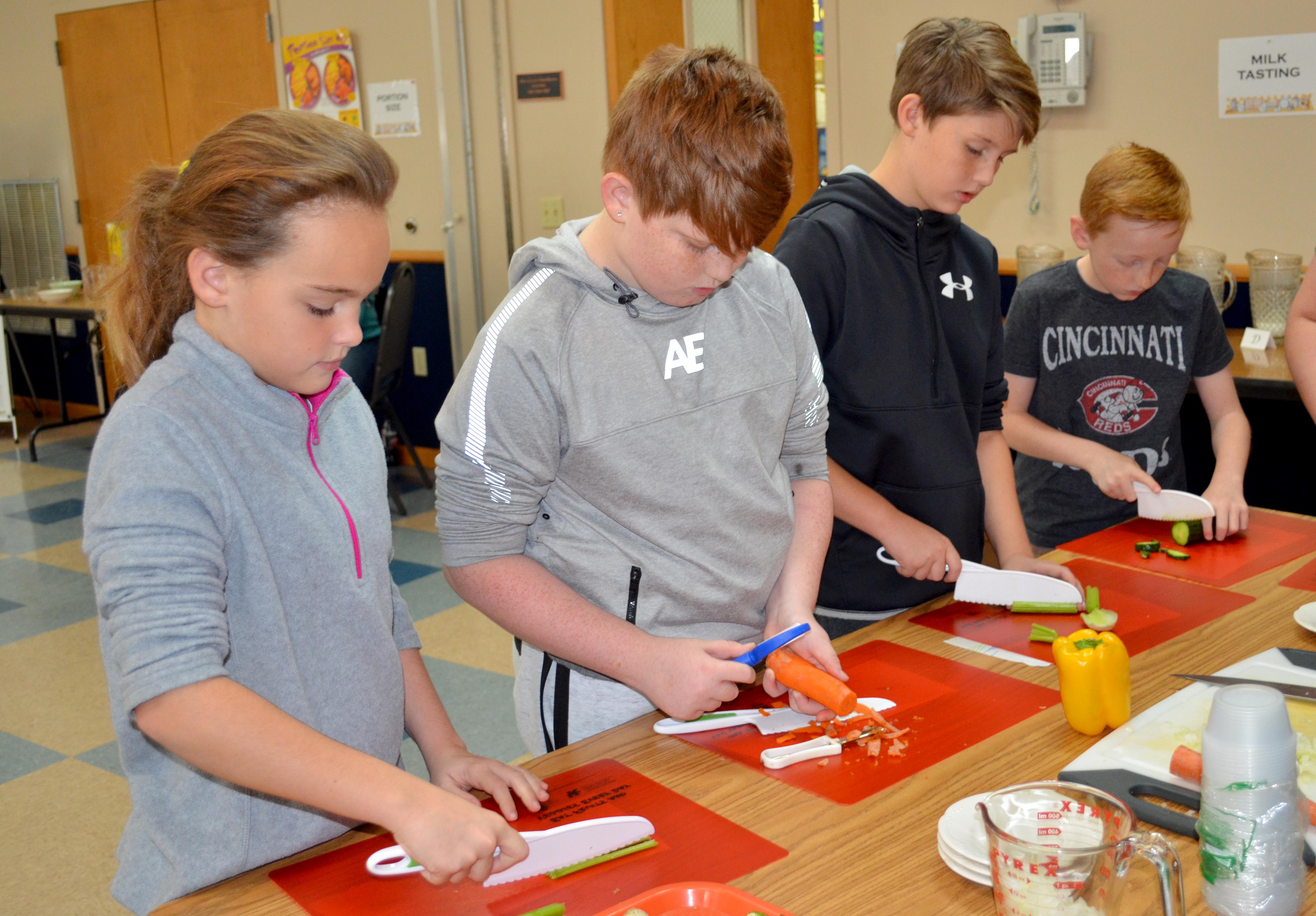 Owen County fifth-graders chop up vegetable appetizers during the Recipes for Life Program. Photo by Katie Pratt, UK agricultural communications.