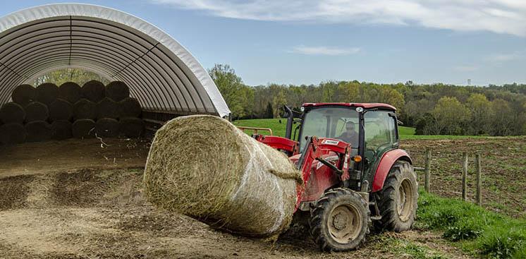 A volunteer collects hay from Smith Farms in New Liberty, Kentucky. Freida Smith donated several hundred round bales to a statewide Cooperative Extension drive to help farmers in flood-torn Nebraska. Photo by Carol Lea Spence