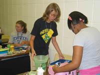 Emma Huff (left), Jorden Patterson (middle) and Madison Cannon (right) put the finishing touches on their products for the “Entrepreneurship for Teens” class during the 2006 4-H Teen Conference.