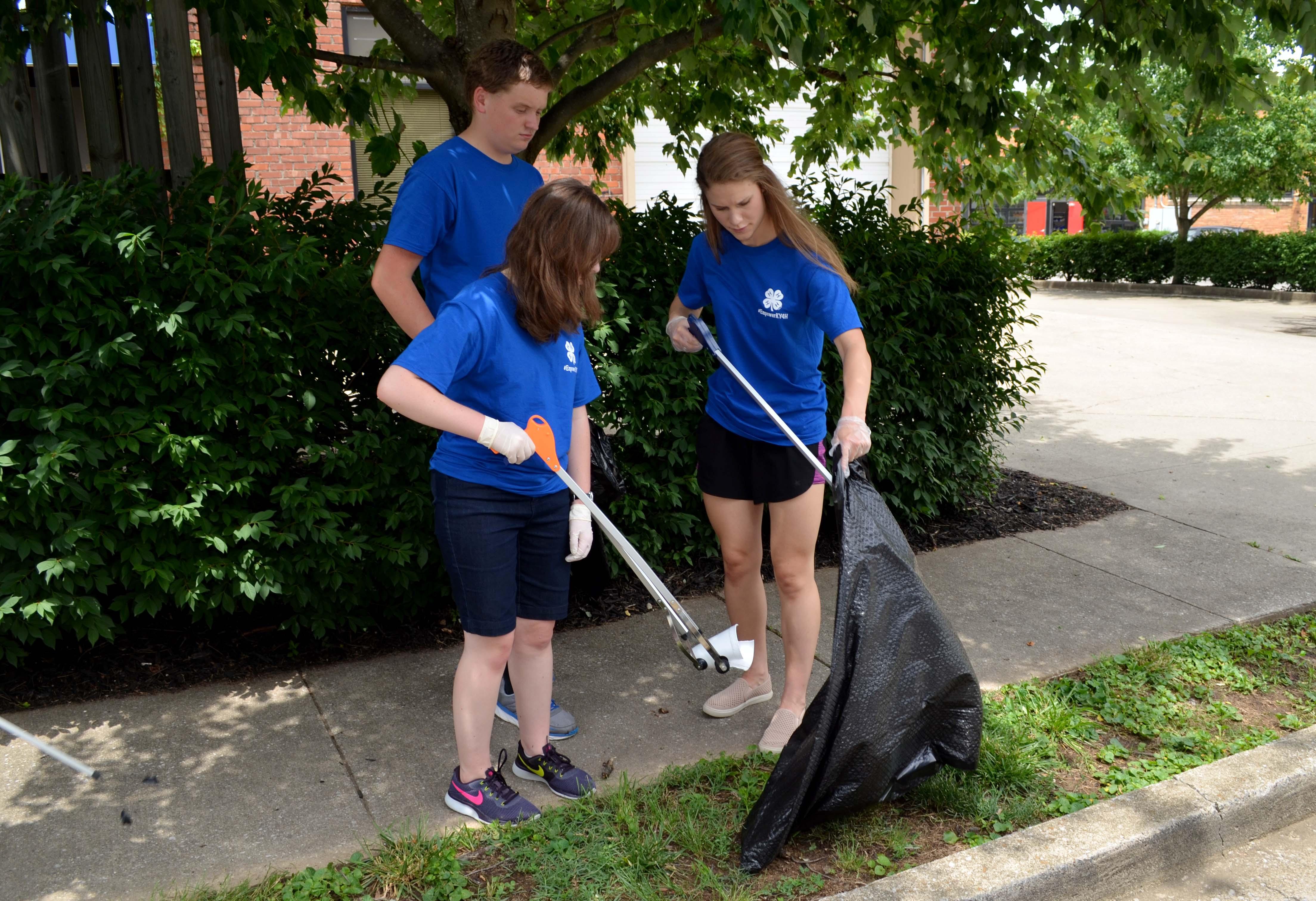 Kentucky 4-H'ers pick up litter in a Lexington community as part of their community service project at 4-H Teen Conference.