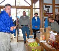 Mark Reese, far left, and tour participants listen to a presentation at Amerson Farm Orchard.