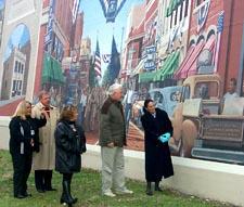 From left to right: Micah Williamson, Mayor Roger Hensley, Nikki Baker, Sid Rice, and Suellen Zornes enjoy the detail of a mural of the old Front Street in Catlettsburg