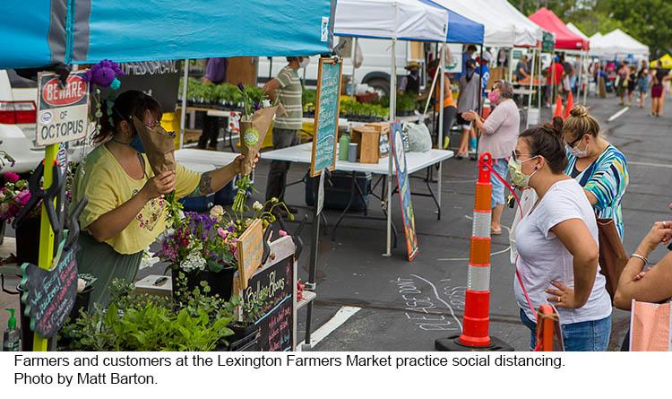 Cutomers practice social distancing at the Lexington Farmers Market.