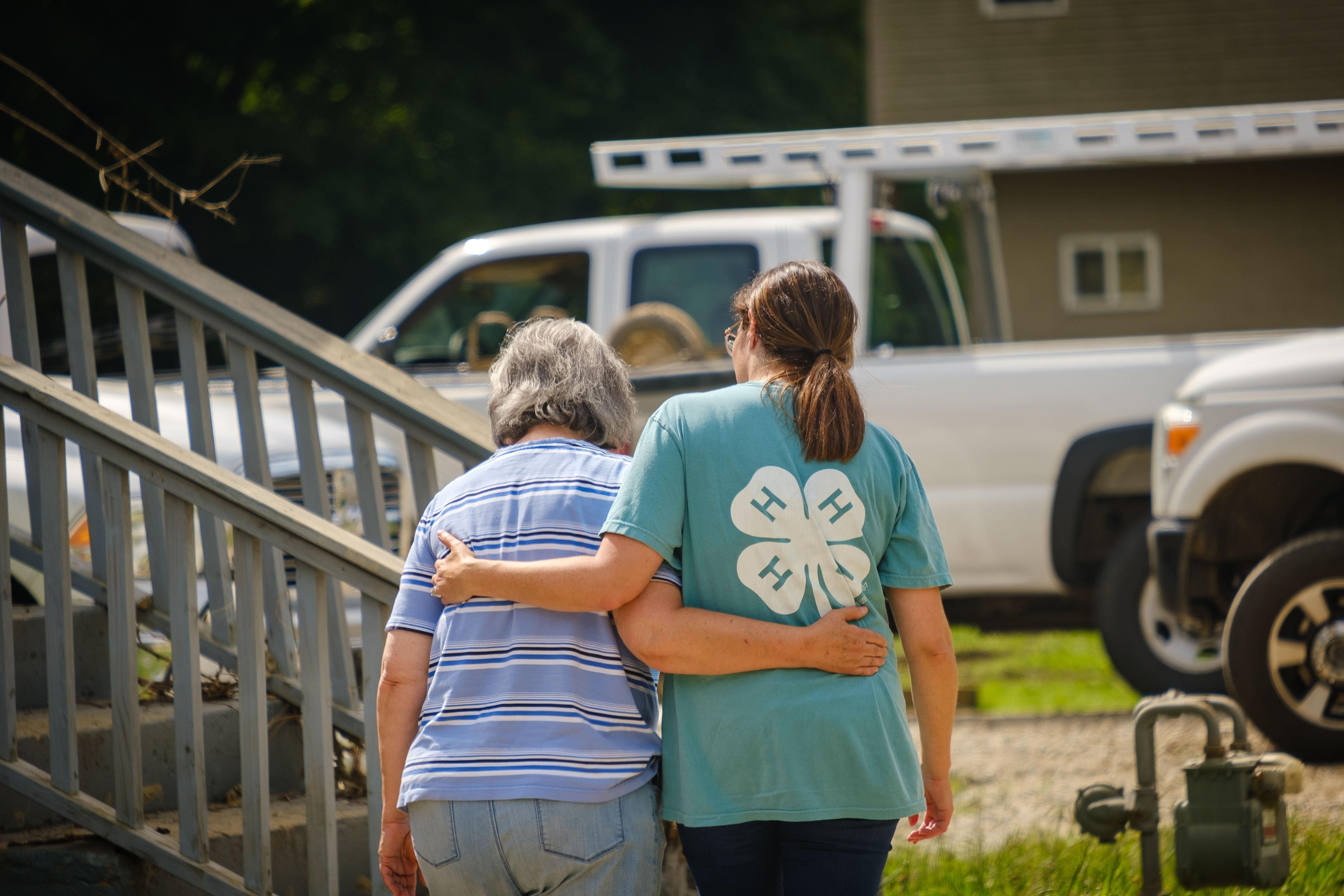 Knott County 4-H Youth Development extension agent Dora Center, right, comforts a woman in Caney. Photo by Matt Barton, UK Agricultural Communications Specialist