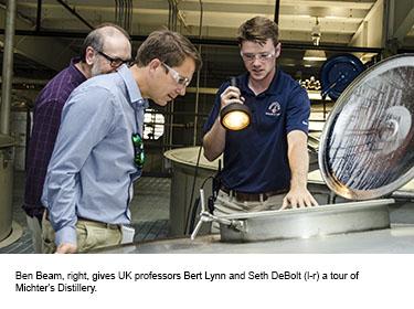 Ben Beam, right, gives UK professors Bert Lynn and Seth DeBolt (l-r) a tour of Michter's Distillery.