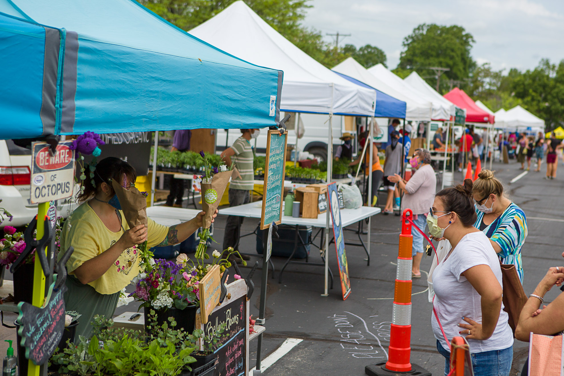 Farmers and customers practice social distancing at the Lexington Farmers Market. Photo by Matt Barton