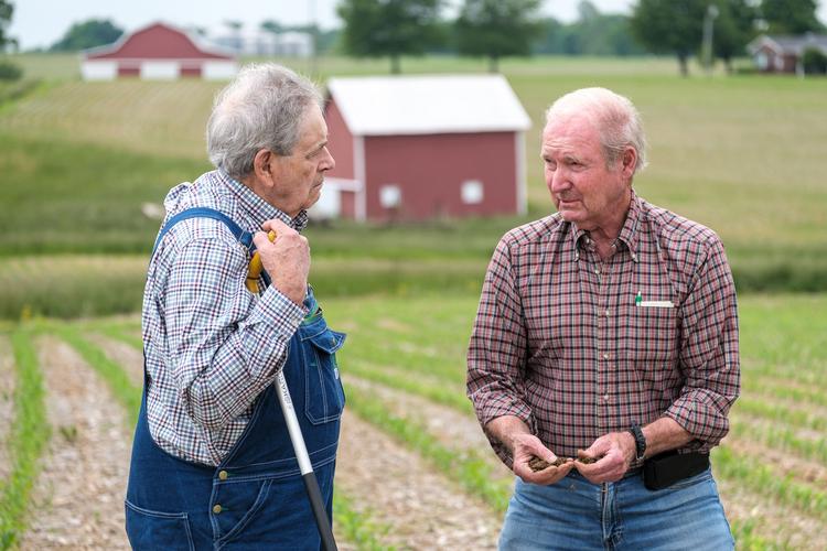 Todd County farmer and no-till row cleaner inventor Howard Martin, left, and Lloyd Murdock, UK professor emeritus discuss Martins soil quality on a recent trip to his farm. Photo by Matt Barton, UK agricultural communications.