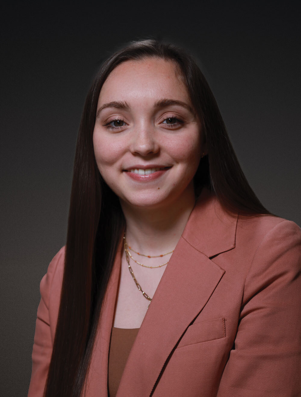 A woman poses for a professional portrait